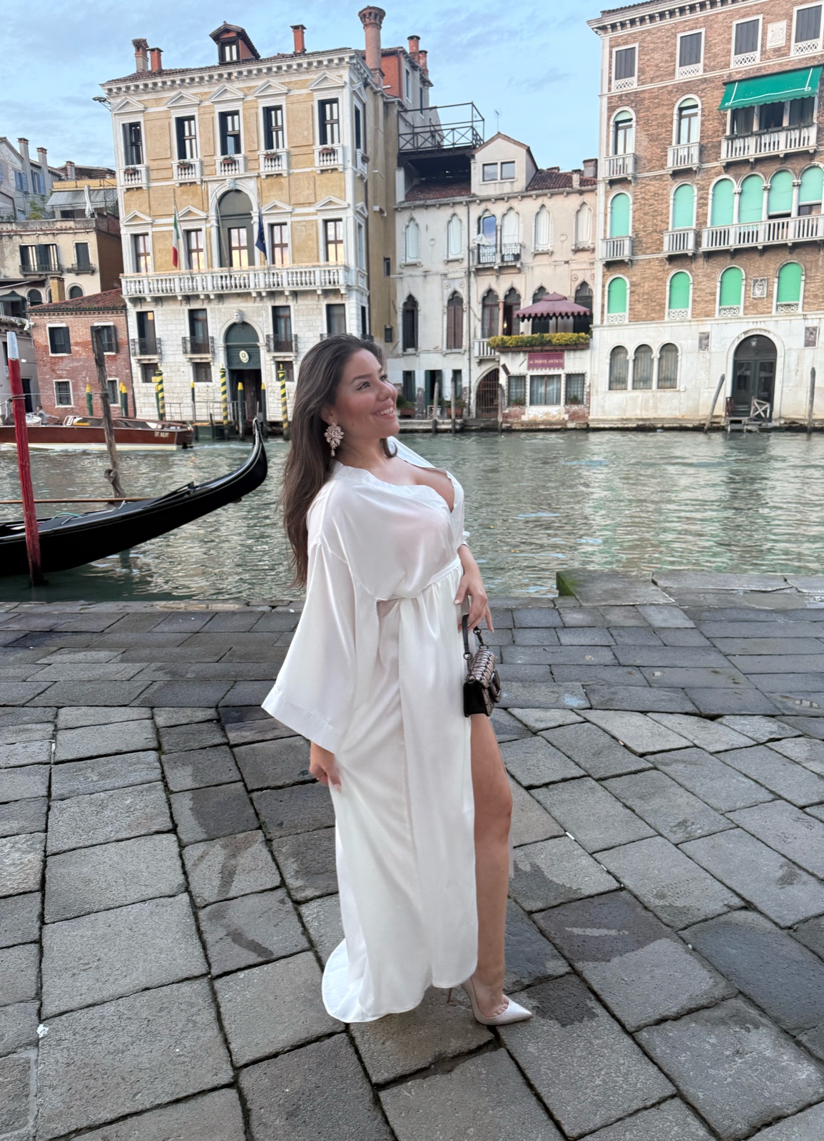 Editorial portrait of Maria Elena Cismarescu on the Grand Canal in Venice, in a cream dress.