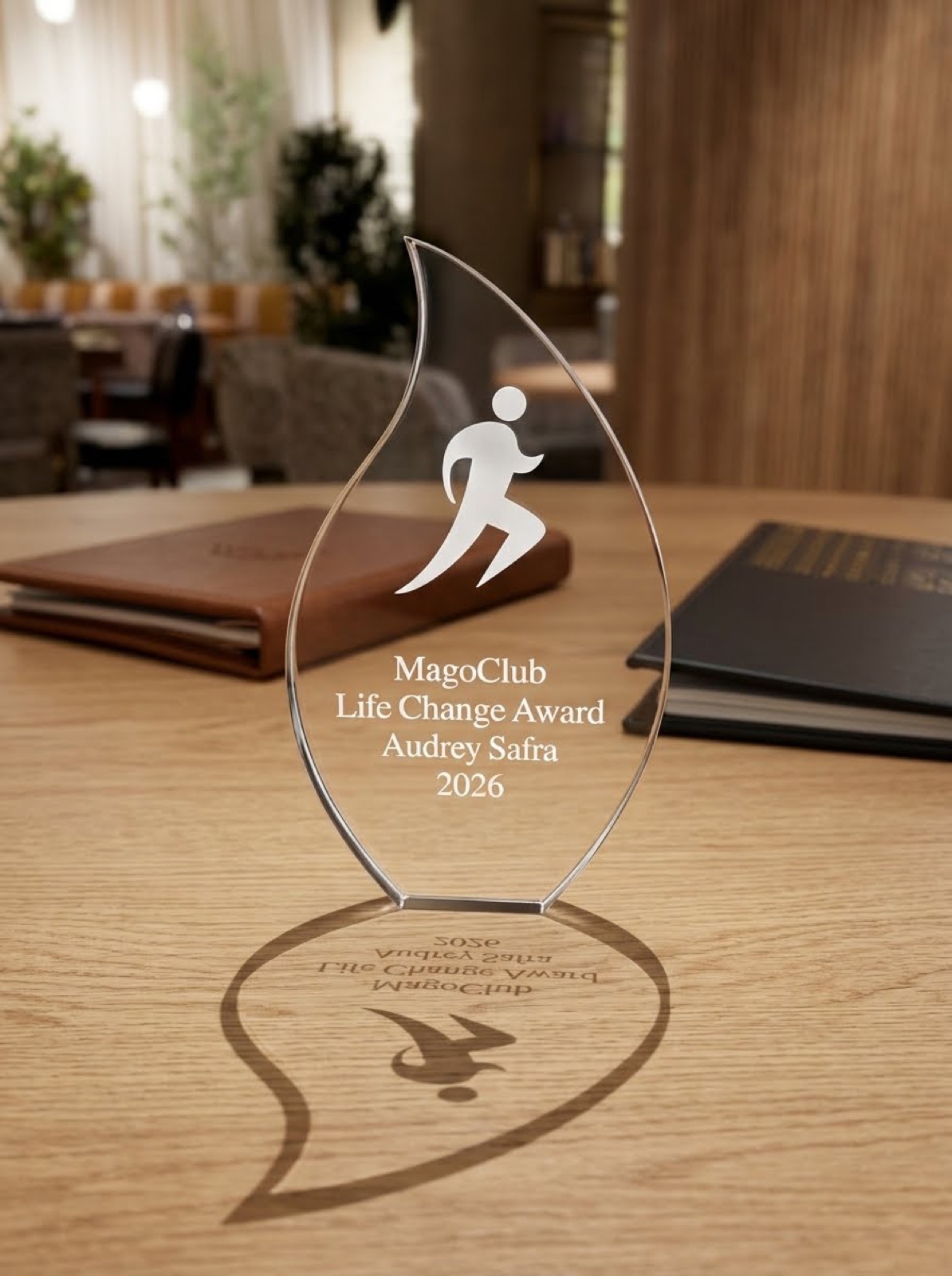 A MAGOCLUB Life Change Award on a table in a softly lit members’ lounge.